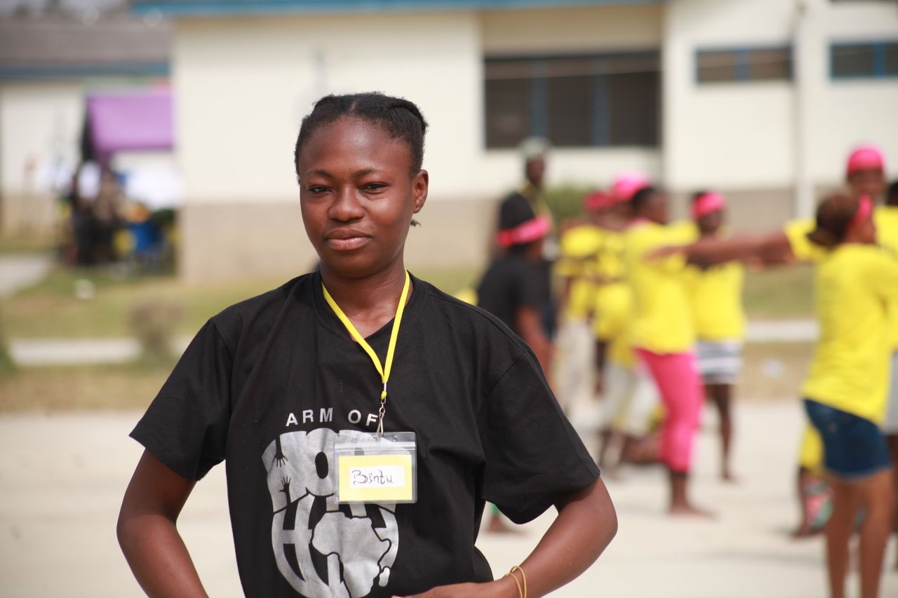 Crafting Captivating Headlines: Your awesome post title goes here Young African teenager wearing a name tag at an outdoor community event.