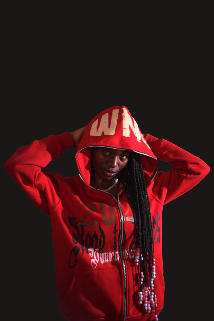 Fashionable woman in red hoodie poses confidently against a dark background. Perfect for fashion and lifestyle themes.