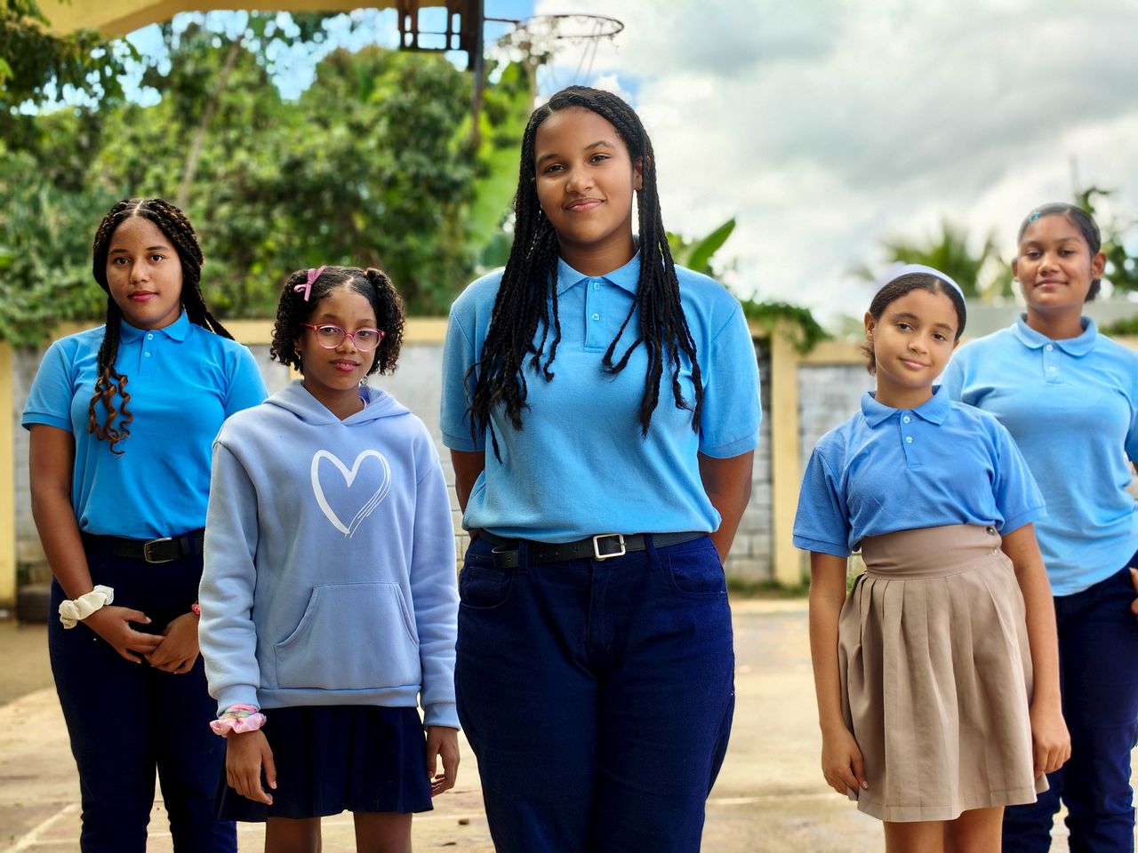 The Art of Drawing Readers In: Your attractive post title goes here A group of school girls wearing blue uniforms standing outdoors, showing unity and diversity.